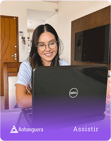 a woman sitting at a table with a laptop