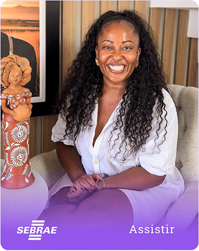 a woman sitting in a chair smiling